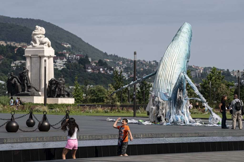 Greenpeace protest plastic pollution with lifesize whales in Budapest