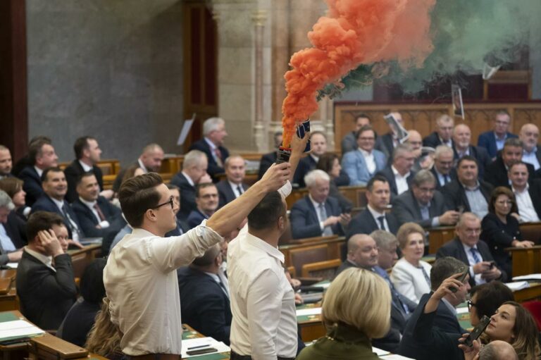 Hungarian Parliament bans Budapest Pride LGBTQ march as opposition protests with smoke bombs.